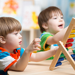 Two kids playing with counting toy